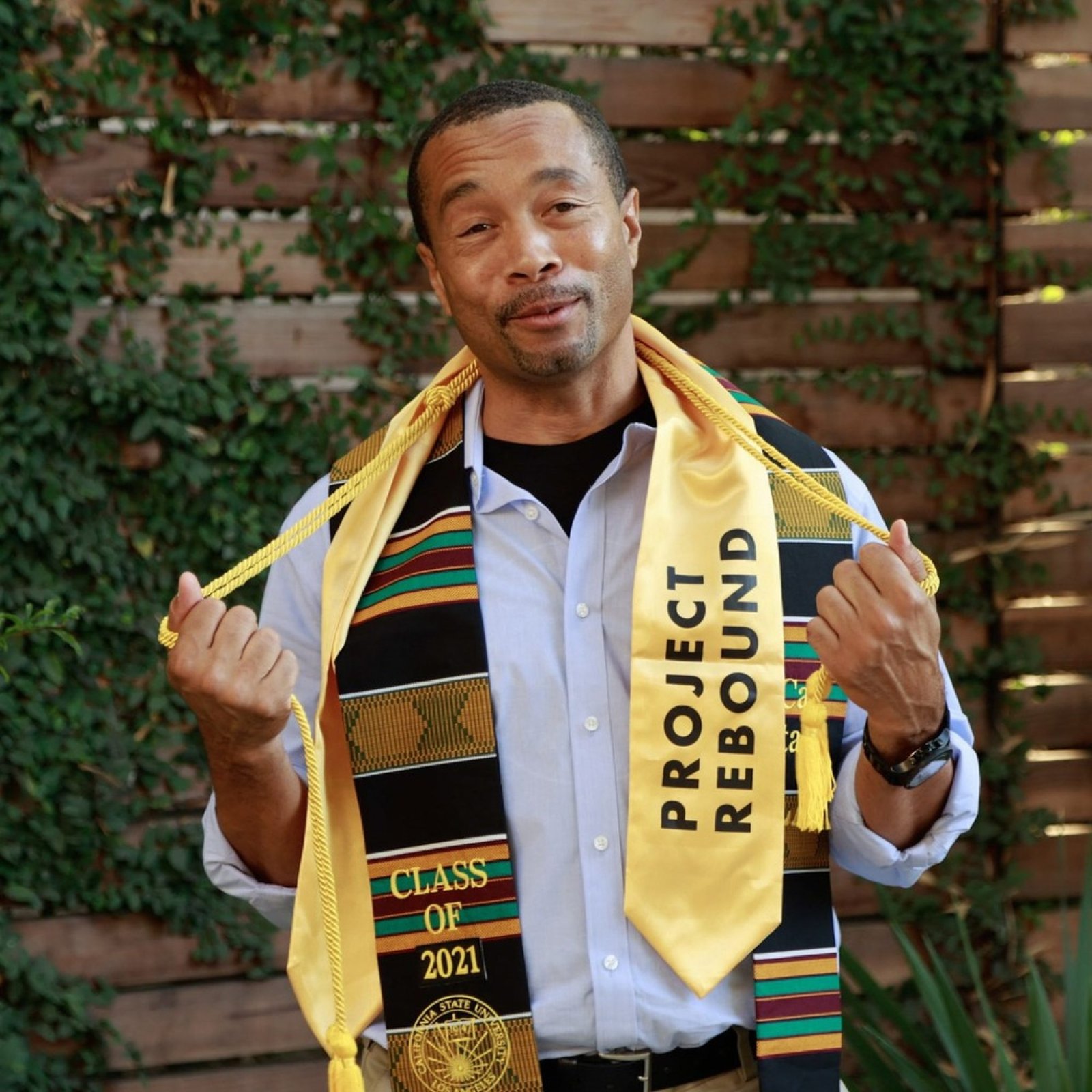 An image of a person formerly sentenced to LWOP wearing academic stoles.