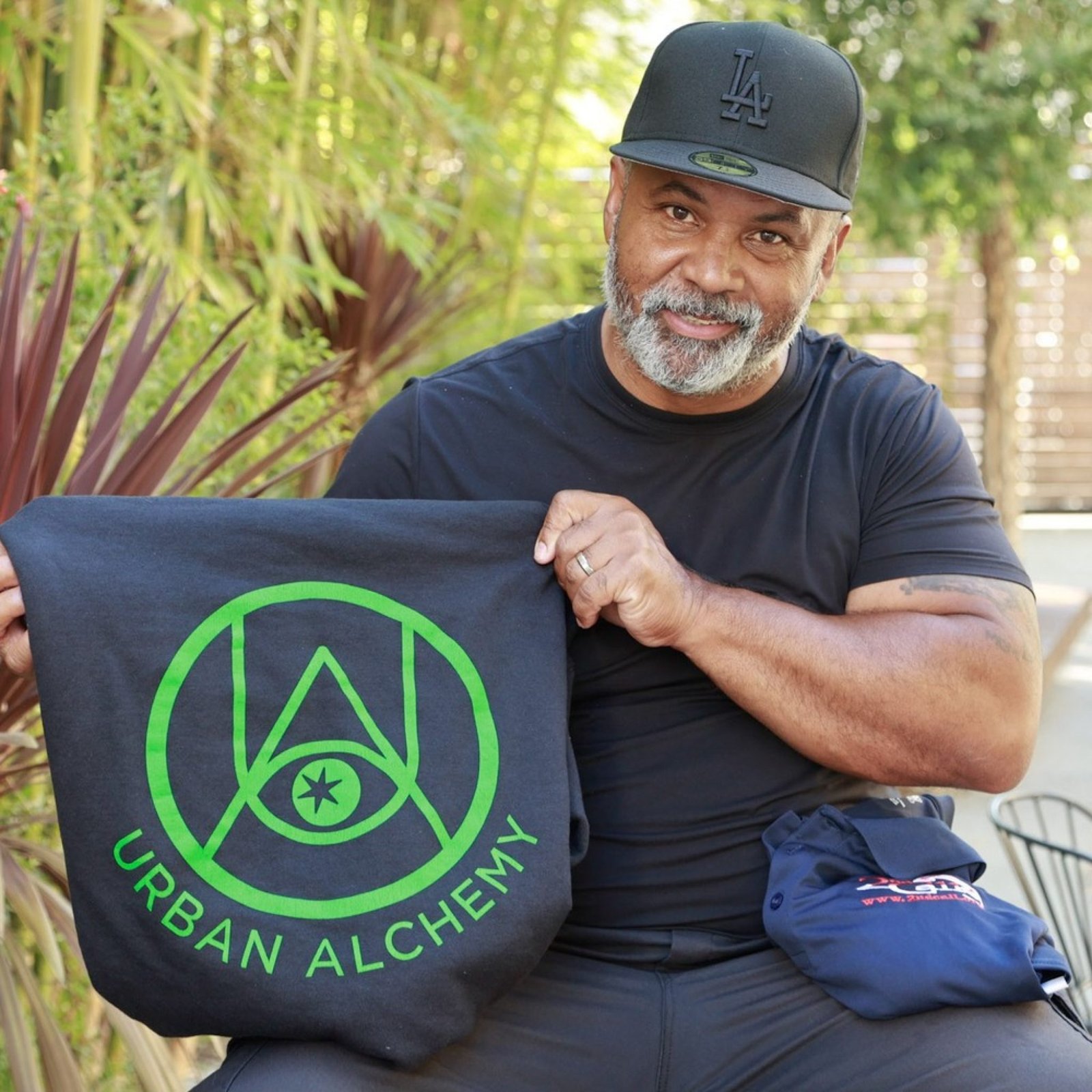 An image of a person formerly sentenced to LWOP holding up a shirt.