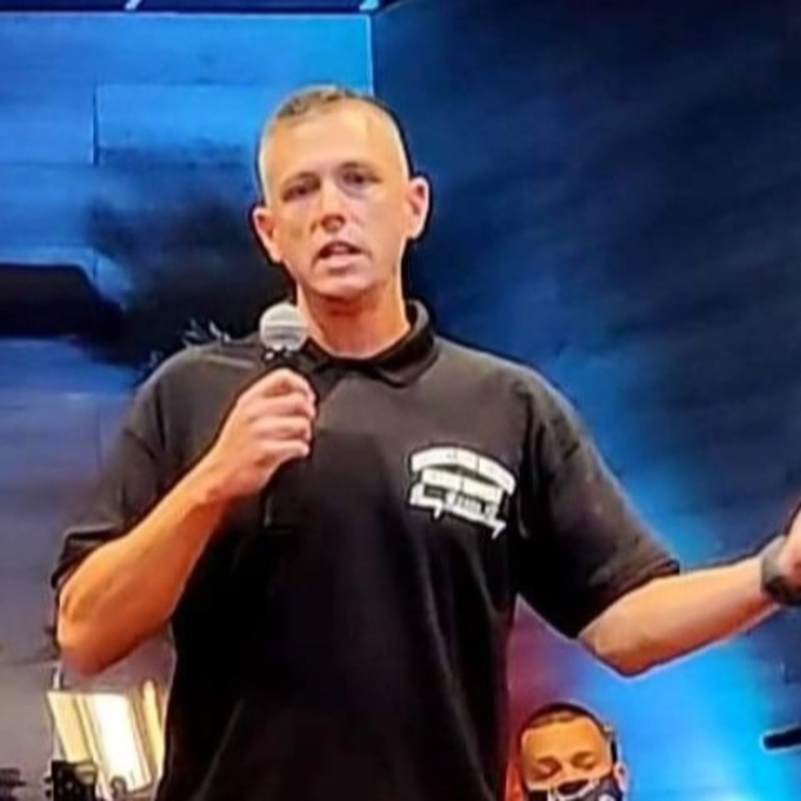 An image of a person formerly sentenced to LWOP speaking into microphone.